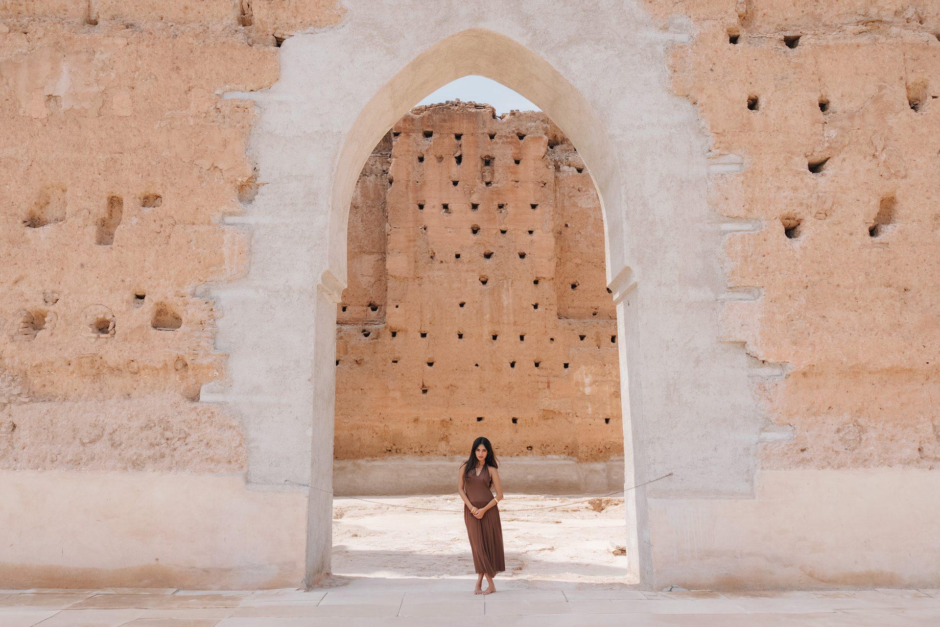 A woman beneath a Moroccan archway.